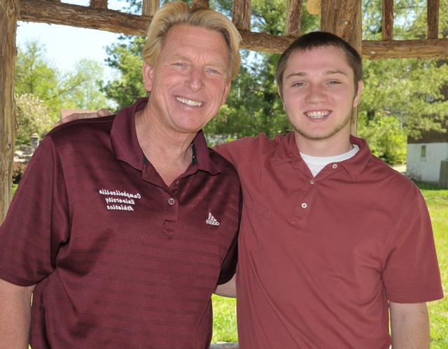 Jordan Ventresco, left, and Dr. Ted Taylor talk in the Turner Log Cabin Park at Campbellsville